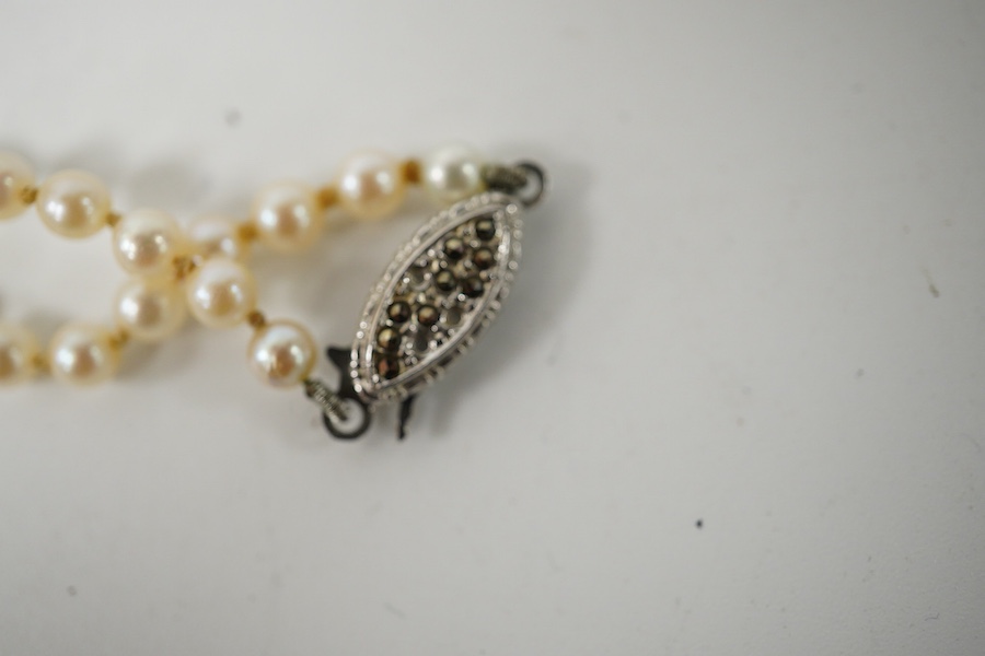 A double strand graduated culture pearl necklace, with marcasite set sterling clasp, 46cm and one other single strand cultured pearl necklace. Condition - fair